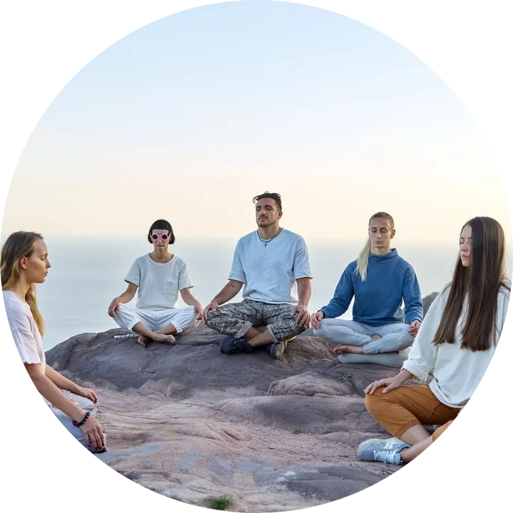 People sitting together in a circle at dawn